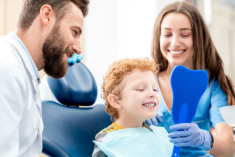 pediatric dentistry patient smiling in mirror
